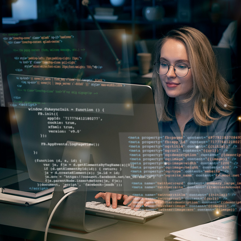 An image of a woman working at a desktop with code on the screen | Cloud Services in Falkirk, IT Support for Small Businesses in Falkirk