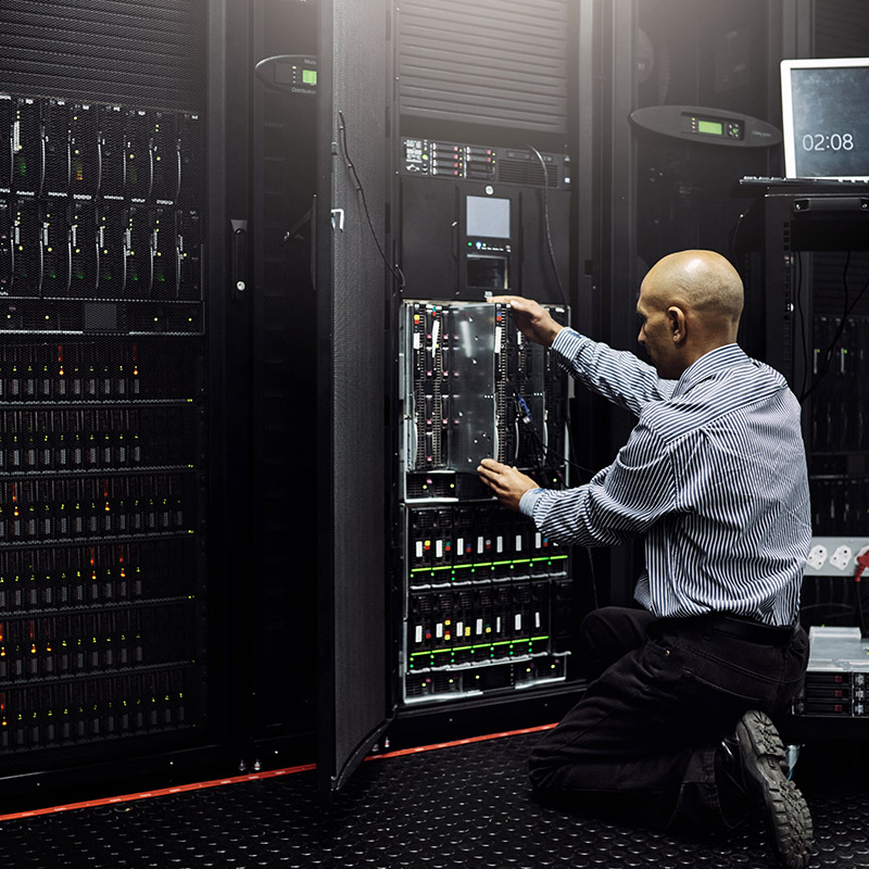 An mage of a man working on a server rack | IT Maintenance in Falkirk