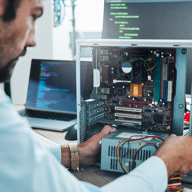 An image of a person fixing a computer unit | IT Maintenance in Falkirk