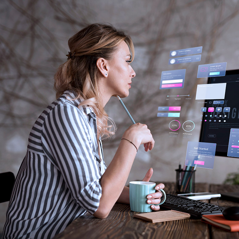 A person working at a desktop with icons overlayed on the screen | Microsoft IT Support in Falkirk